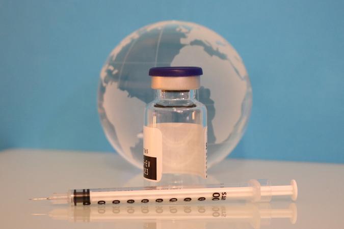 A syringe, vaccine bottle, and glass globe. Credit: NIAID